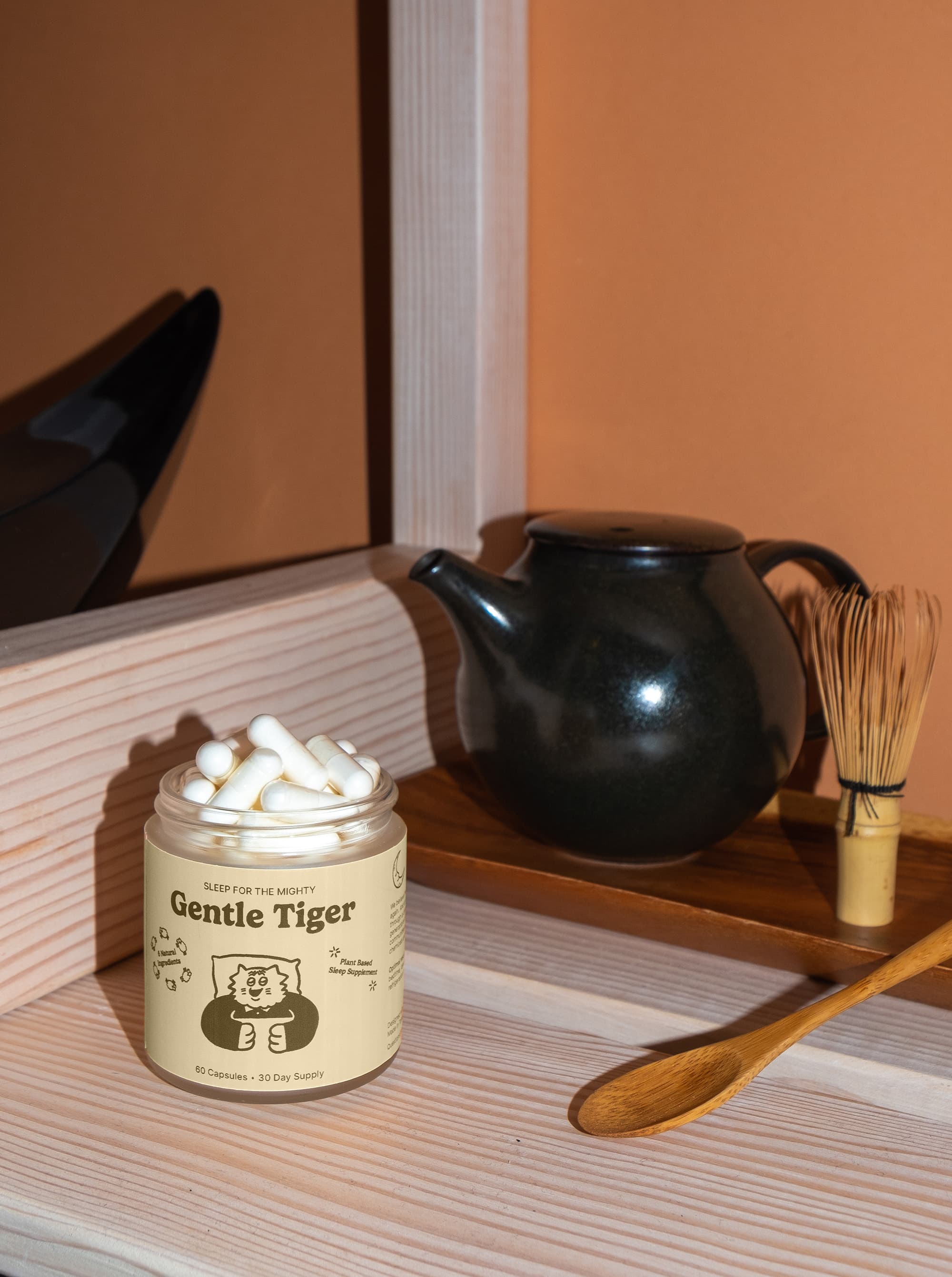 Gentle Tiger capsules beside a matcha tea set in morning light