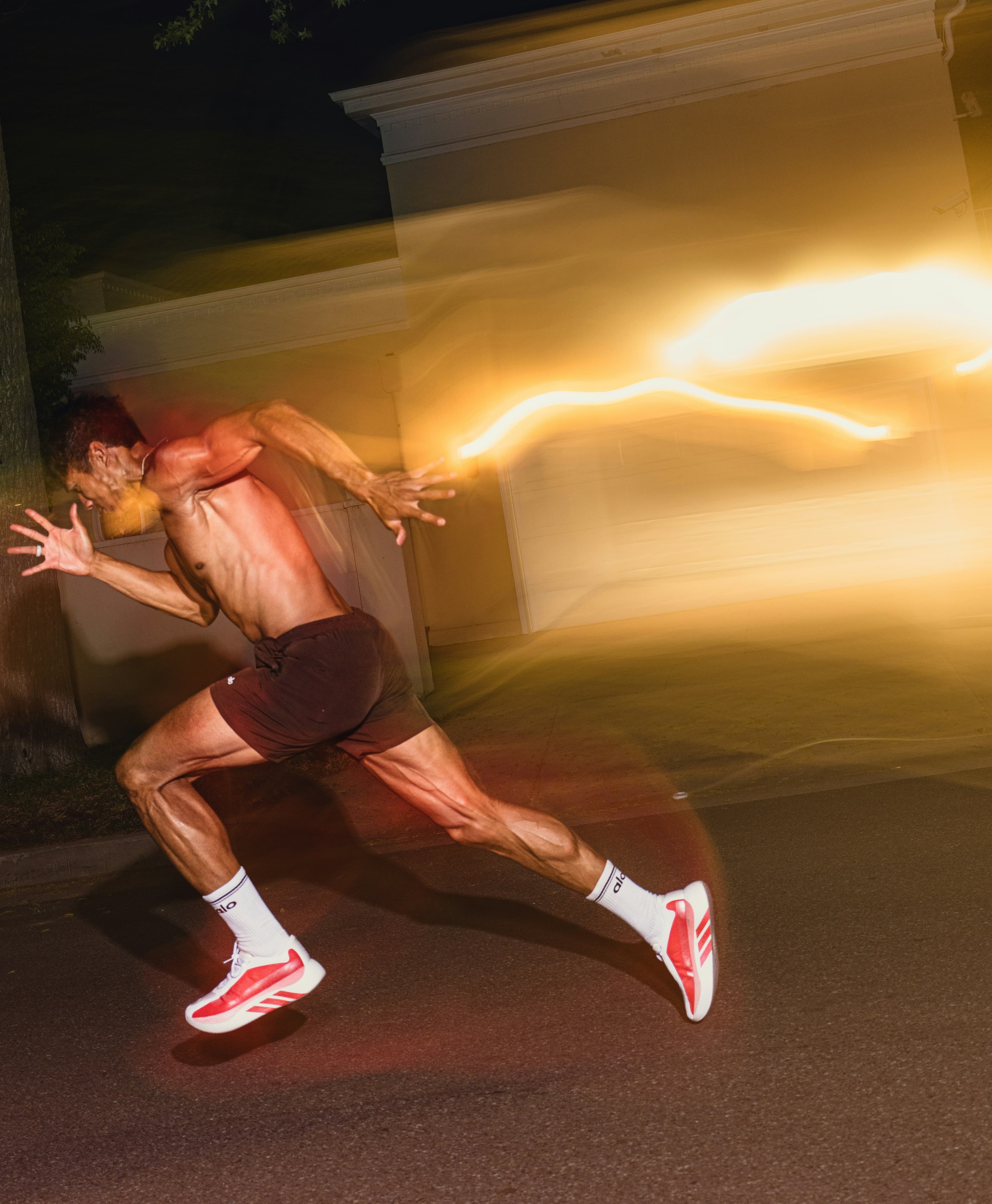 Sprinter breaking through the night with light trails
